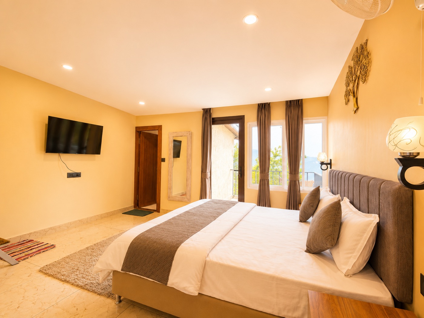 Attic suite main room with TV, staircase and sitting table