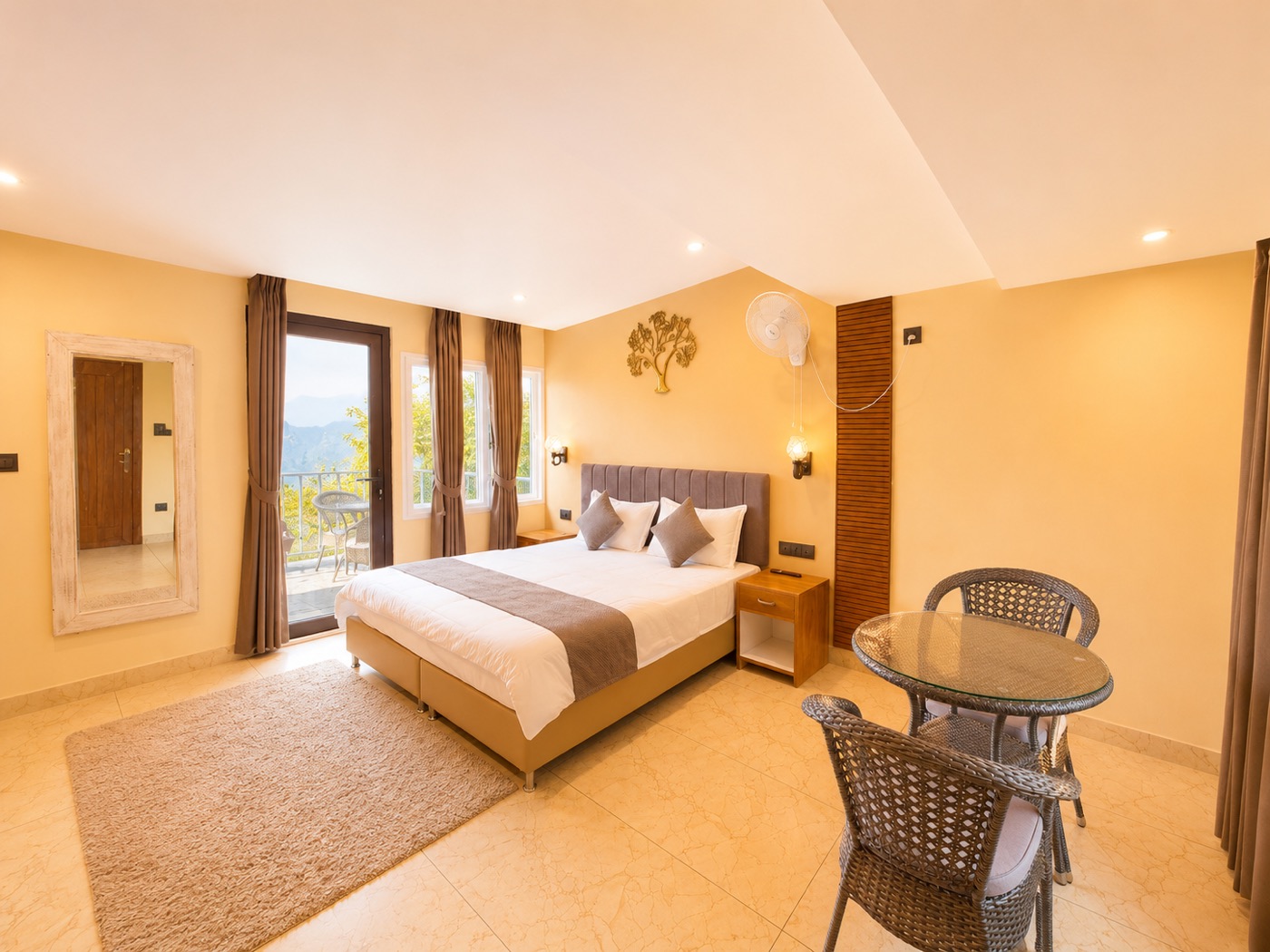 Attic suite with balcony chairs and mountain light